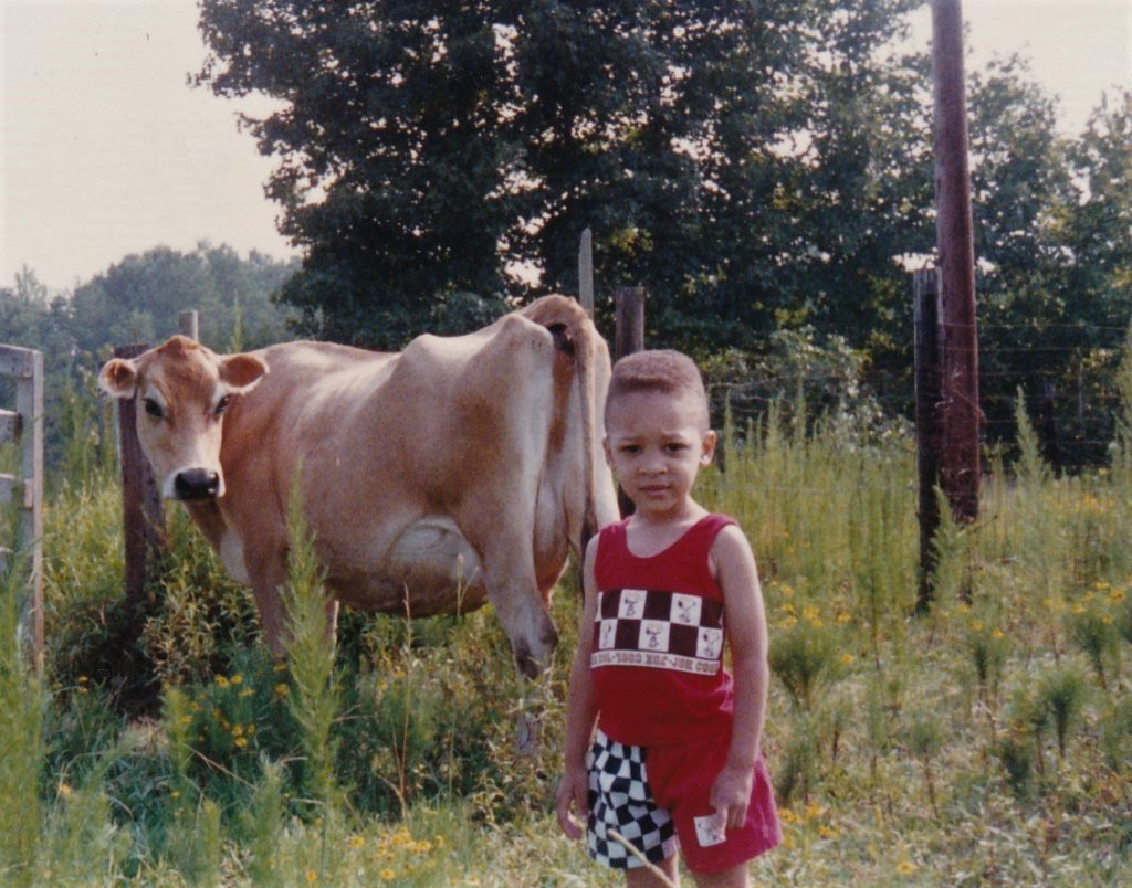 Jack Johnson's Great Grandson Marcus Johnson near cow